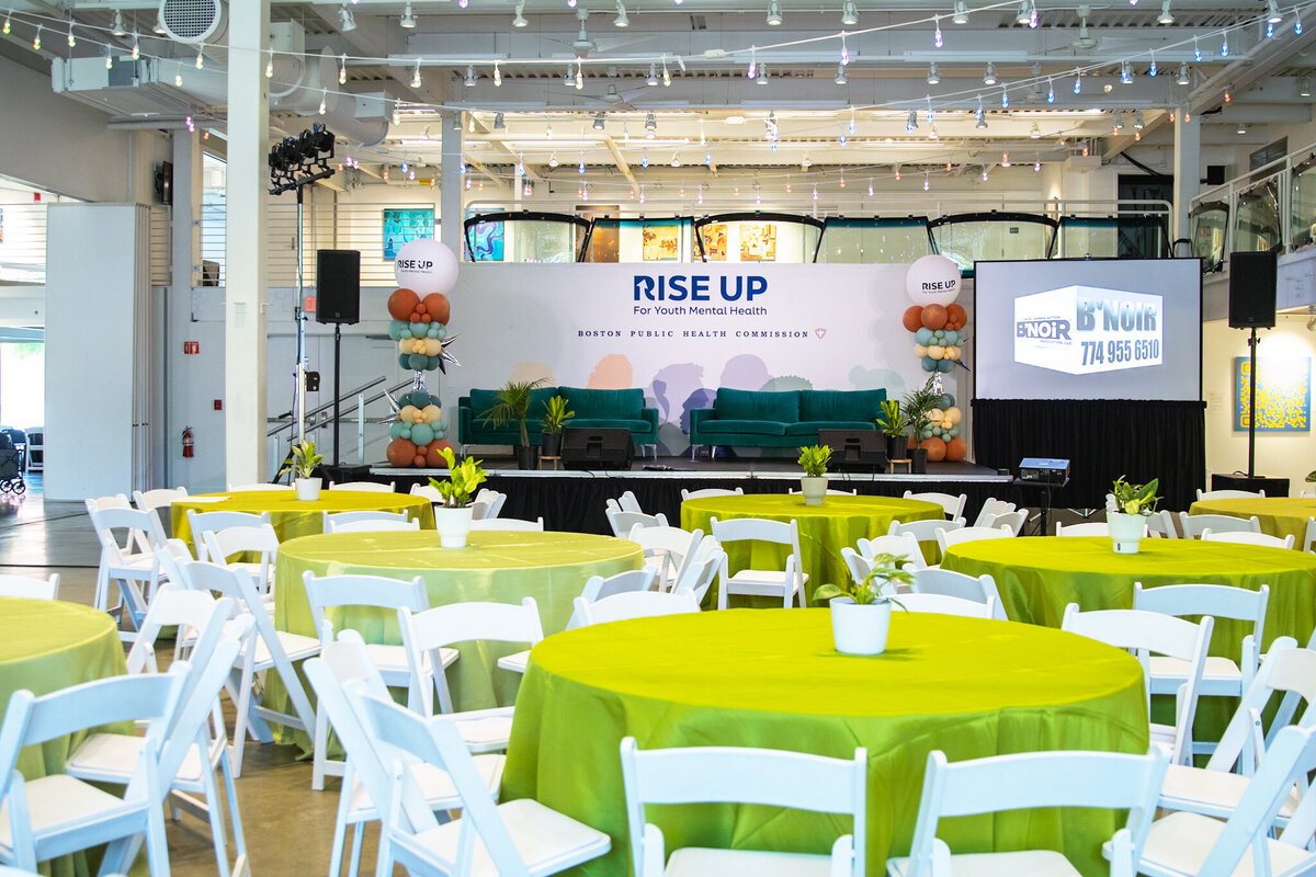 Rise Up summit room with lime tablecloths