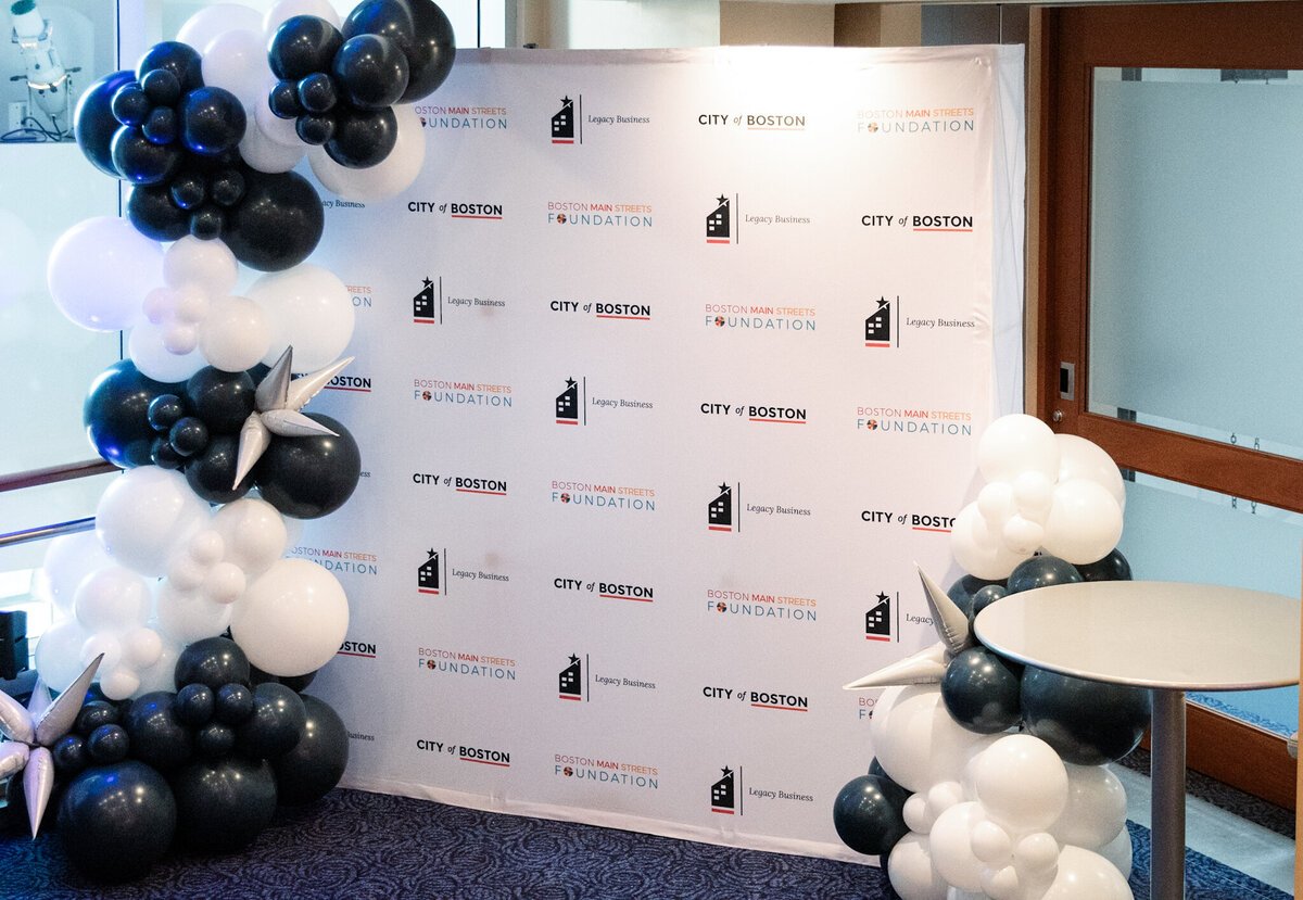 City of Boston step-and-repeat with black and white balloons